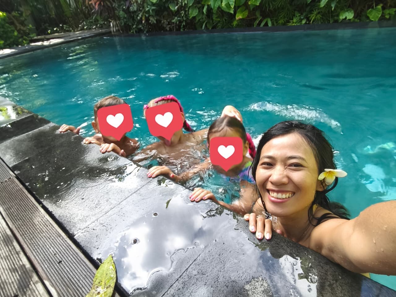 Siti having fun in the pool with children in Bali