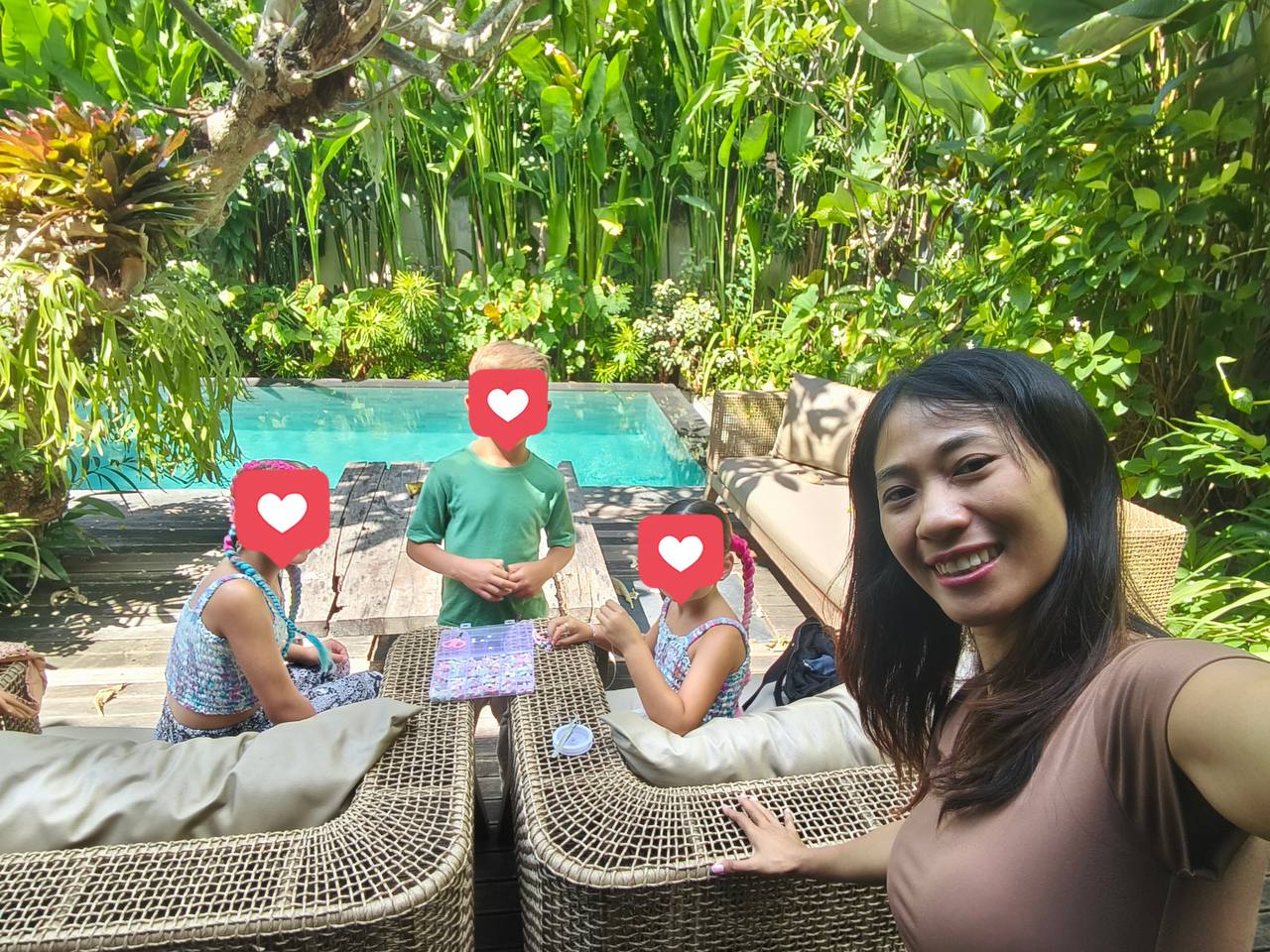 Siti playing a game with children by the pool in Bali